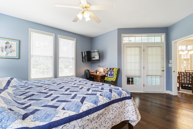 308 Crooked Gulley Cir, Sunset Beach, NC 28468 - bedroom featuring dark wood-style floors, a ceiling fan, a chandelier, and baseboards