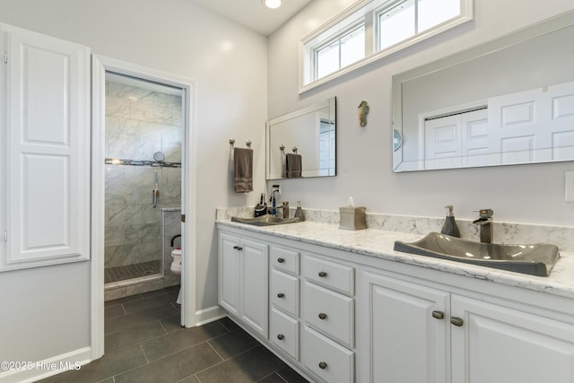 308 Crooked Gulley Cir, Sunset Beach, NC 28468 - bathroom featuring tile patterned floors, baseboards, a stall shower, toilet, and double vanity