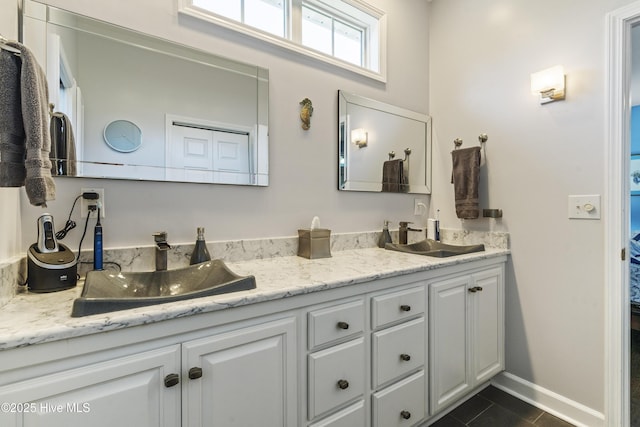 308 Crooked Gulley Cir, Sunset Beach, NC 28468 - full bath with double vanity, tile patterned floors, and baseboards