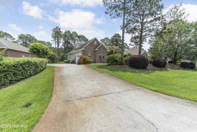 308 Crooked Gulley Cir, Sunset Beach, NC 28468 - view of front of home with concrete driveway, a front yard, and brick siding