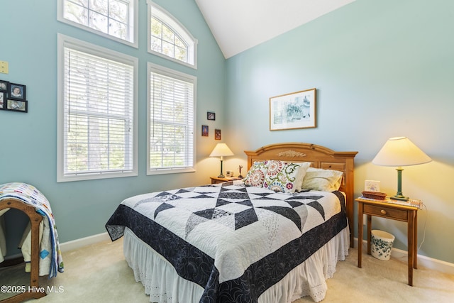308 Crooked Gulley Cir, Sunset Beach, NC 28468 - bedroom with light colored carpet, baseboards, multiple windows, and high vaulted ceiling