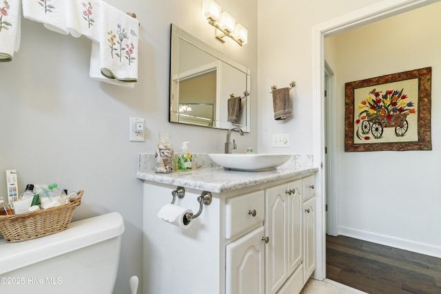 308 Crooked Gulley Cir, Sunset Beach, NC 28468 - bathroom with wood finished floors, baseboards, toilet, and vanity