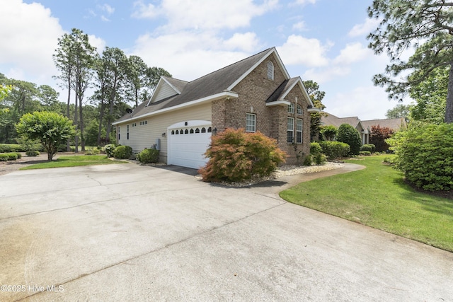 308 Crooked Gulley Cir, Sunset Beach, NC 28468 - view of side of home with a lawn, concrete driveway, brick siding, and an attached garage