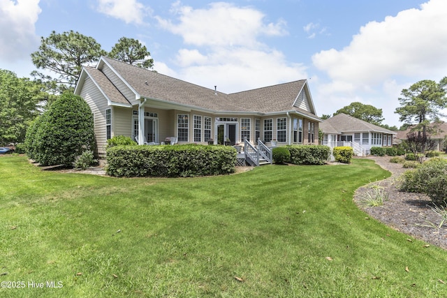 308 Crooked Gulley Cir, Sunset Beach, NC 28468 - back of house featuring a lawn and roof with shingles