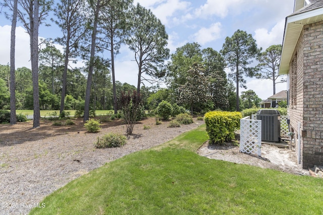 308 Crooked Gulley Cir, Sunset Beach, NC 28468 - view of grassy yard featuring central air condition unit