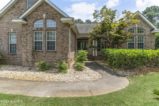 308 Crooked Gulley Cir, Sunset Beach, NC 28468 - traditional-style house with brick siding and a shingled roof