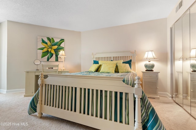 2000 New River Inlet Rd Unit 3113, North Topsail Beach, NC 28460 - carpeted bedroom with baseboards, a textured ceiling, and a closet
