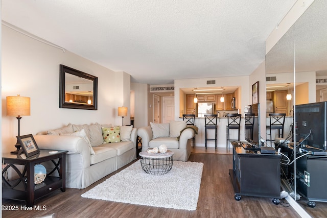 2000 New River Inlet Rd Unit 3113, North Topsail Beach, NC 28460 - living area with dark wood-style floors and a textured ceiling