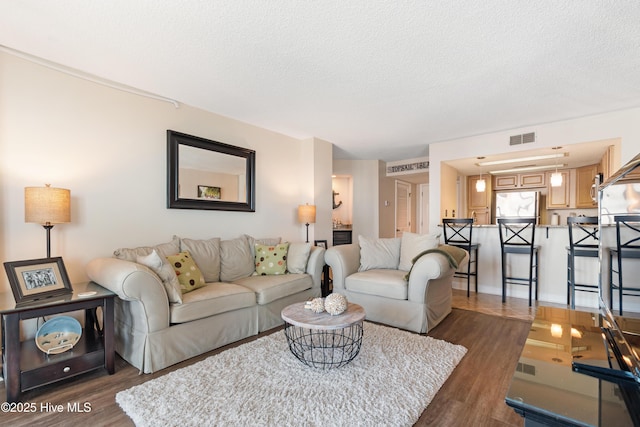 2000 New River Inlet Rd Unit 3113, North Topsail Beach, NC 28460 - living area with wood finished floors and a textured ceiling