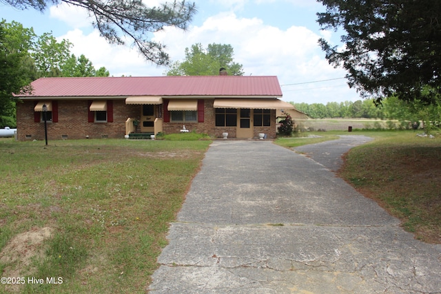 2489 Rodgers School Rd, Williamston, NC 27892 - view of front of house featuring asphalt driveway, metal roof, crawl space, and a front yard
