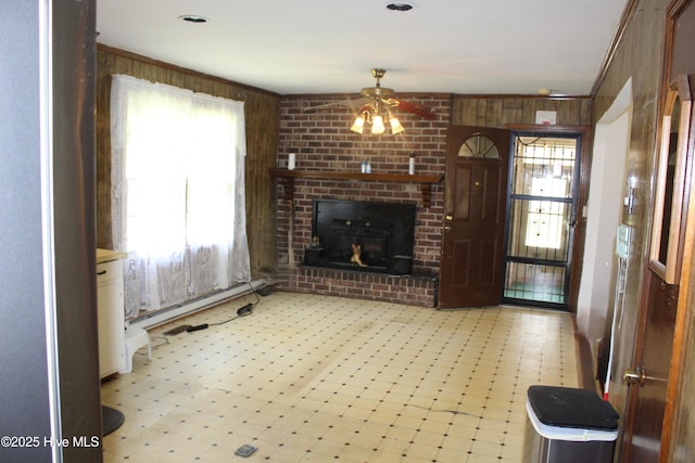 2489 Rodgers School Rd, Williamston, NC 27892 - unfurnished living room with light floors, wooden walls, a baseboard heating unit, and a ceiling fan