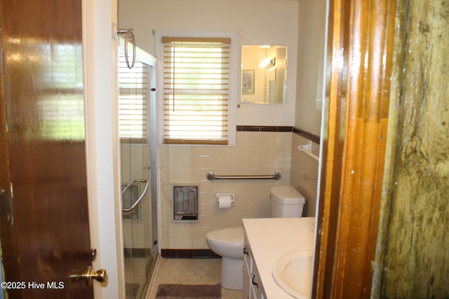 2489 Rodgers School Rd, Williamston, NC 27892 - bathroom with vanity, tile walls, a shower stall, toilet, and a wainscoted wall