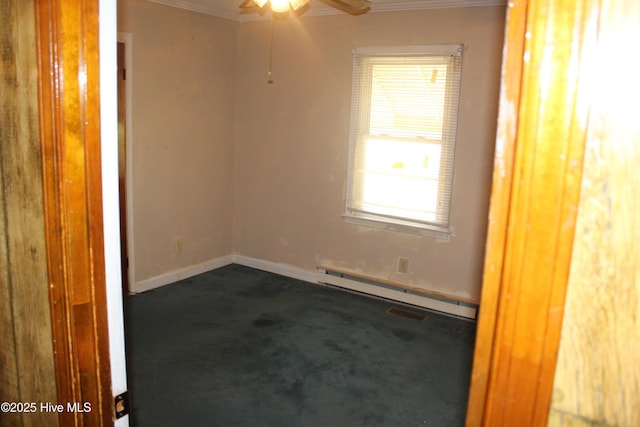 2489 Rodgers School Rd, Williamston, NC 27892 - unfurnished room with dark carpet, baseboard heating, ornamental molding, a ceiling fan, and baseboards