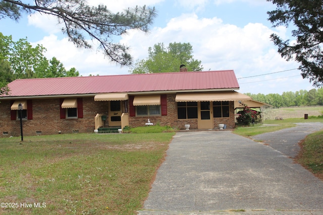 2489 Rodgers School Rd, Williamston, NC 27892 - ranch-style house with crawl space, driveway, metal roof, and a front lawn