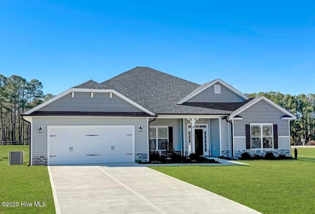 view of front of property featuring an attached garage, a front lawn, driveway, and a porch