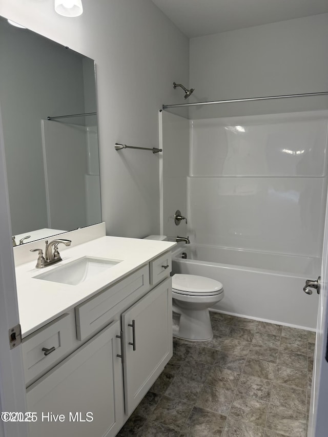 bathroom featuring toilet, vanity, and shower / bath combination