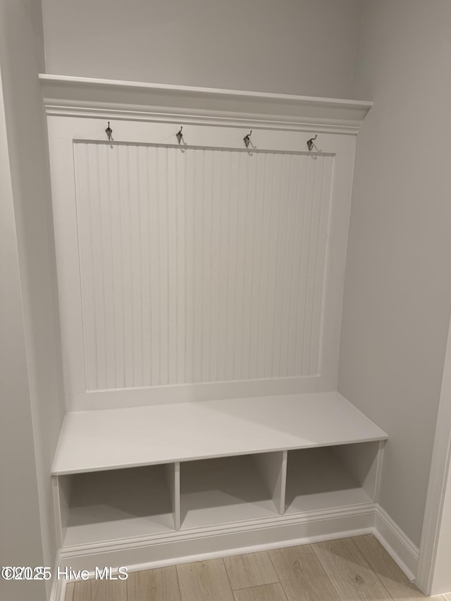 mudroom with wood finished floors and baseboards