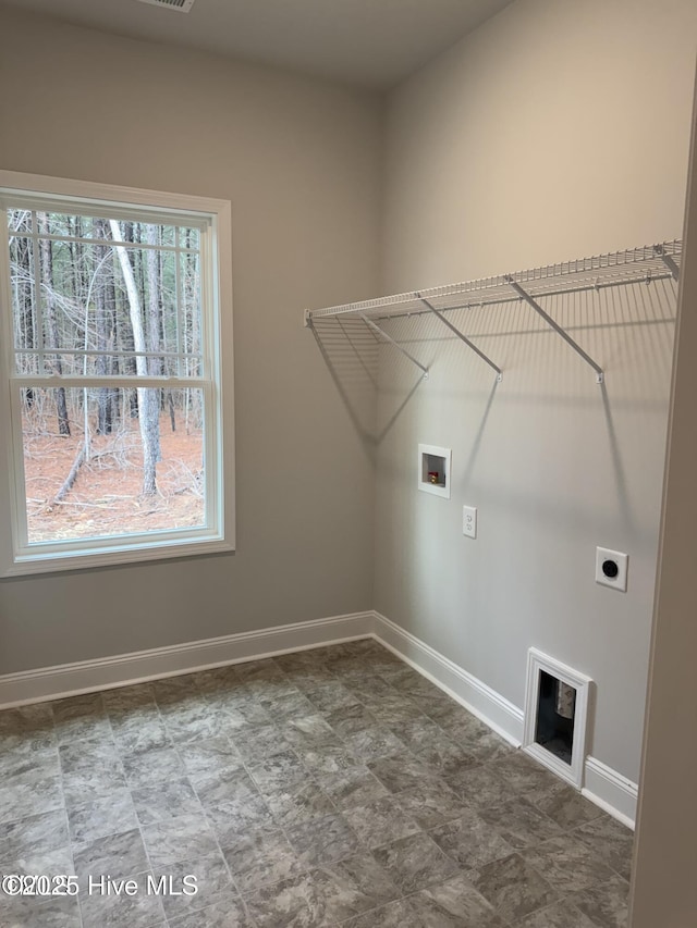 laundry room with hookup for a washing machine, baseboards, and electric dryer hookup