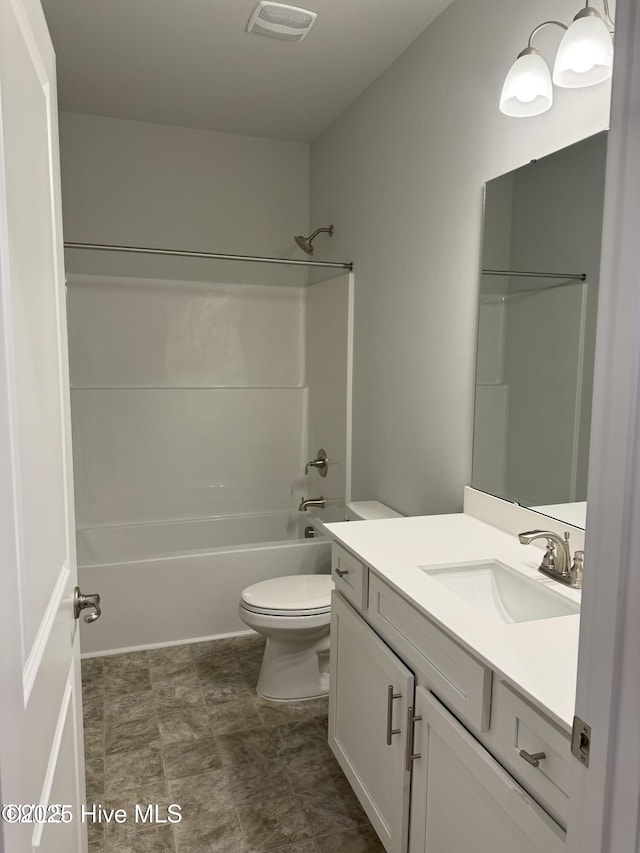 bathroom with toilet, vanity, and shower / tub combination