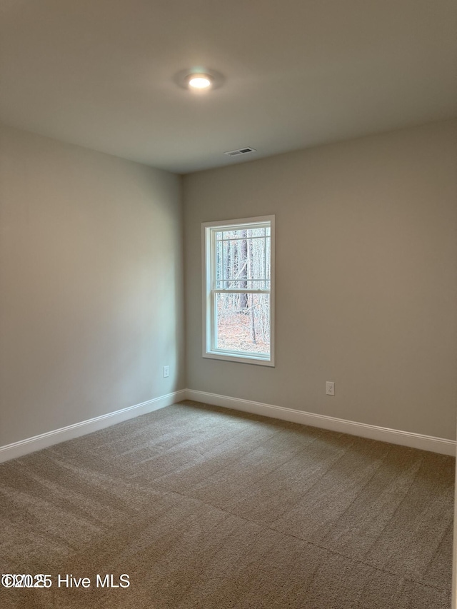 empty room with carpet floors and baseboards