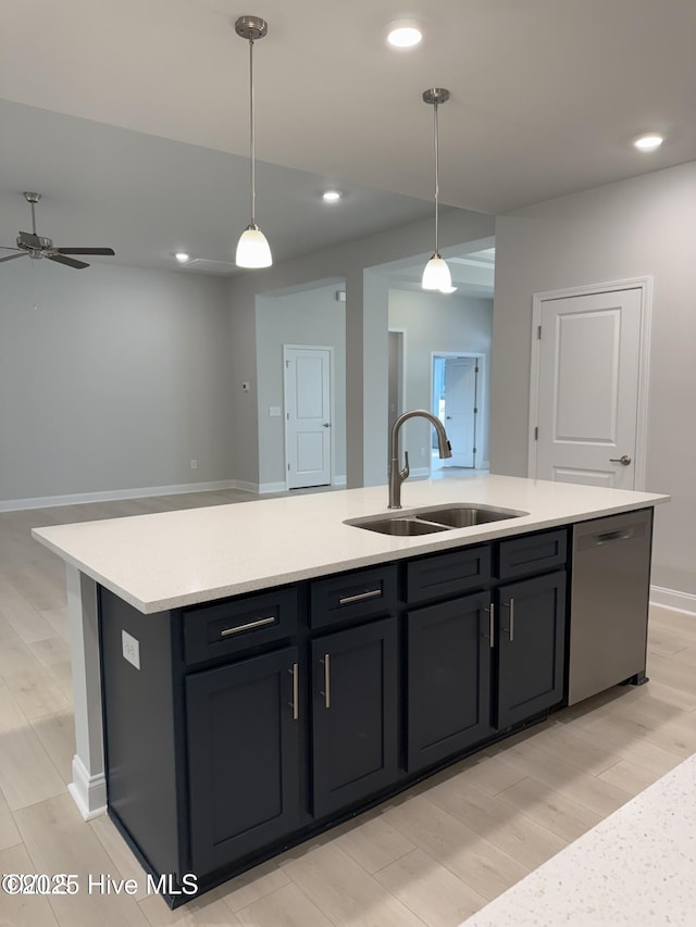 kitchen with dishwasher, a sink, open floor plan, a kitchen island with sink, and ceiling fan