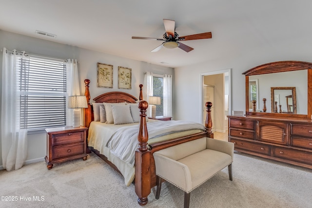 815 Avington Ln NE, Leland, NC 28451 - bedroom with light carpet, ceiling fan, baseboards, and ensuite bath