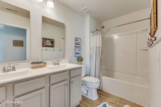 815 Avington Ln NE, Leland, NC 28451 - full bath with wood finished floors, toilet, double vanity, and shower / bathtub combination with curtain