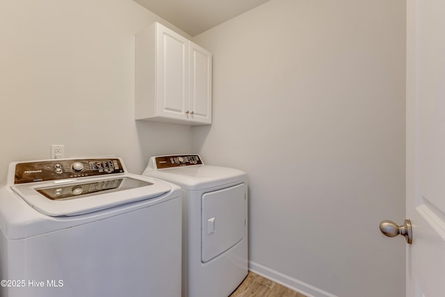 815 Avington Ln NE, Leland, NC 28451 - washroom featuring independent washer and dryer, cabinet space, light wood-style floors, and baseboards