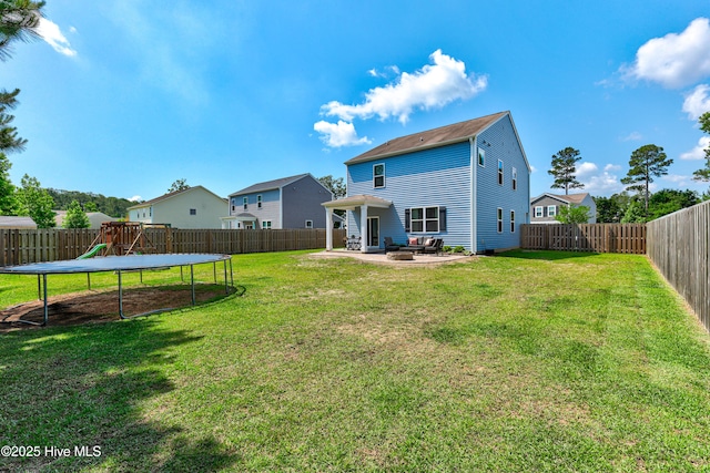 815 Avington Ln NE, Leland, NC 28451 - back of house featuring a trampoline, a patio area, and a playground