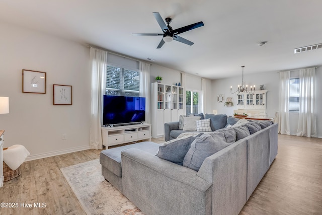 815 Avington Ln NE, Leland, NC 28451 - living room with a chandelier, light wood finished floors, a ceiling fan, and baseboards