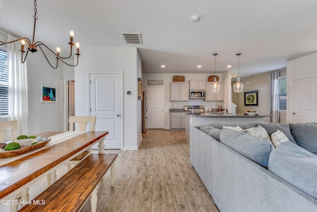 815 Avington Ln NE, Leland, NC 28451 - living room with a chandelier, light wood-style flooring, and recessed lighting