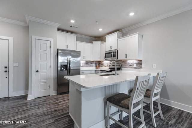 395 S Crow Creek Dr Unit 1601, Calabash, NC 28467 - kitchen with appliances with stainless steel finishes, ornamental molding, a peninsula, baseboards, and dark wood finished floors
