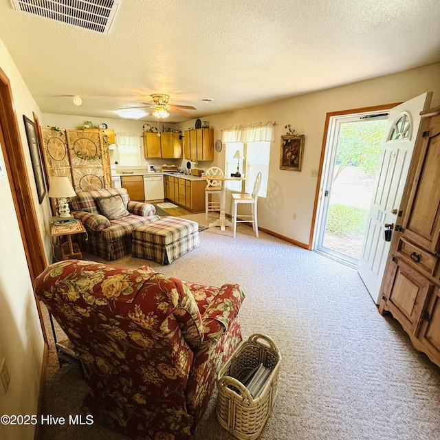 117 Navaho Trl, Edenton, NC 27932 - living room with light carpet, a textured ceiling, baseboards, and a ceiling fan