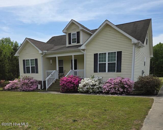 view of front of home with a porch and a front yard