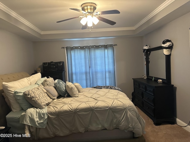 bedroom featuring carpet floors, crown molding, a raised ceiling, and ceiling fan