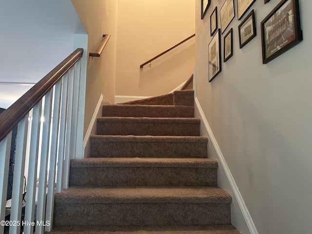 staircase featuring baseboards