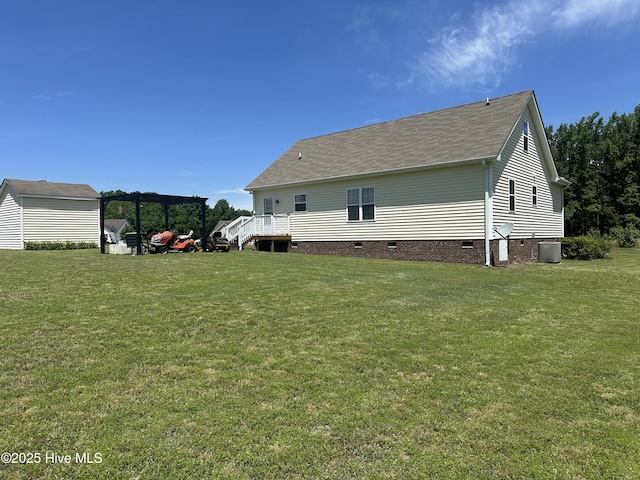 rear view of property with crawl space, central air condition unit, a yard, and roof with shingles