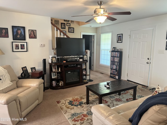 living area featuring a ceiling fan and light carpet