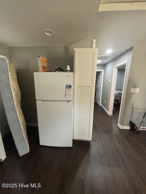 5106 Hodge St, Fayetteville, NC 28303 - kitchen with freestanding refrigerator, dark wood-style floors, white cabinets, baseboards, and recessed lighting