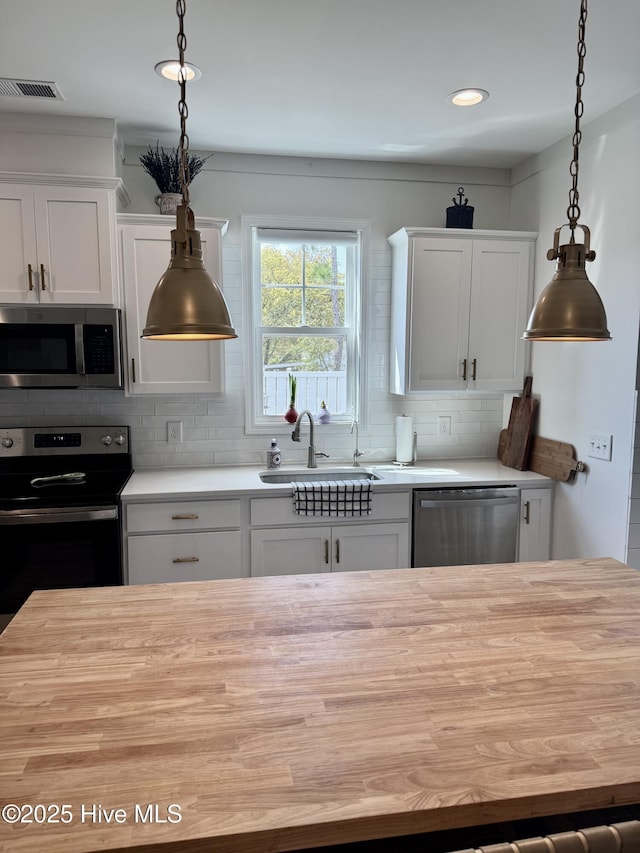 264 Great Egret Way, Beaufort, NC 28516 - kitchen with stainless steel appliances, wood counters, tasteful backsplash, a sink, and recessed lighting