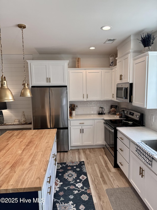 264 Great Egret Way, Beaufort, NC 28516 - kitchen featuring stainless steel appliances, white cabinets, butcher block counters, tasteful backsplash, and light wood-style flooring