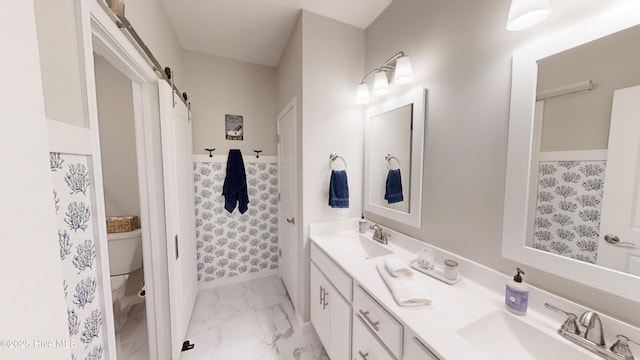 264 Great Egret Way, Beaufort, NC 28516 - bathroom with double vanity, marble look tiles, baseboards, and toilet