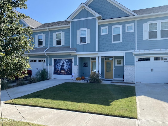 264 Great Egret Way, Beaufort, NC 28516 - view of front of house featuring board and batten siding, a front lawn, concrete driveway, a garage, and brick siding