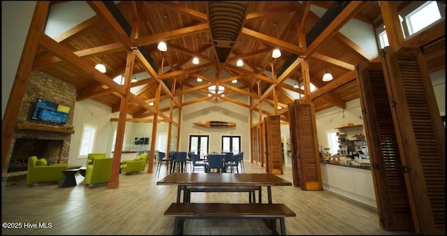 264 Great Egret Way, Beaufort, NC 28516 - dining area with high vaulted ceiling, a fireplace, wood finished floors, and beam ceiling