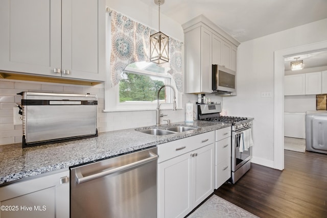 1047 US Highway 158 W, Gates, NC 27937 - kitchen with stainless steel appliances, a sink, washer / clothes dryer, dark wood-style floors, and backsplash