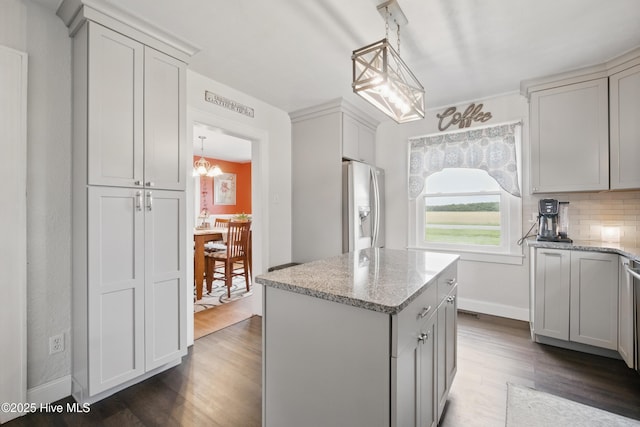 1047 US Highway 158 W, Gates, NC 27937 - kitchen with stainless steel fridge, dark wood-type flooring, a chandelier, a kitchen island, and decorative backsplash