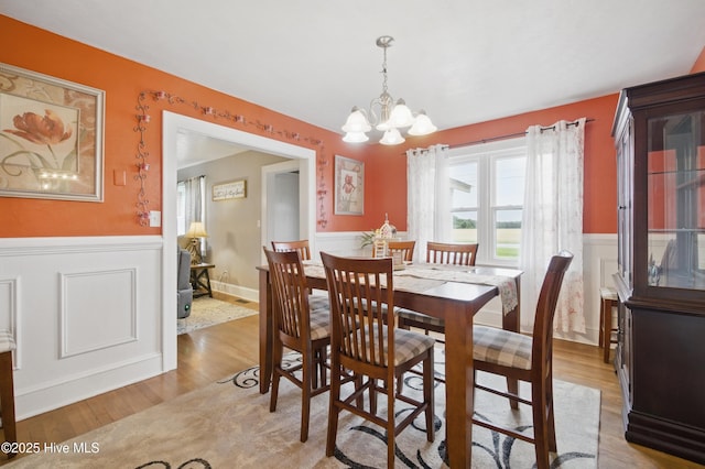 1047 US Highway 158 W, Gates, NC 27937 - dining room featuring wainscoting, a chandelier, light wood finished floors, and a decorative wall