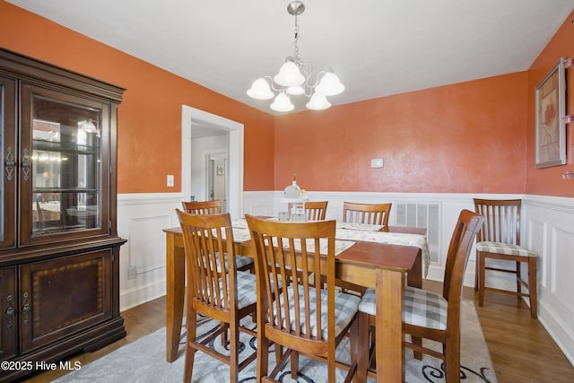 1047 US Highway 158 W, Gates, NC 27937 - dining area with wood finished floors, a chandelier, wainscoting, and a decorative wall