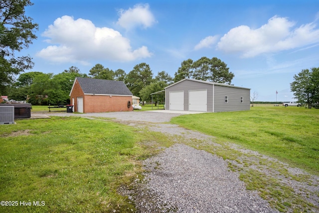 1047 US Highway 158 W, Gates, NC 27937 - view of grassy yard with a detached garage, an outbuilding, and central air condition unit