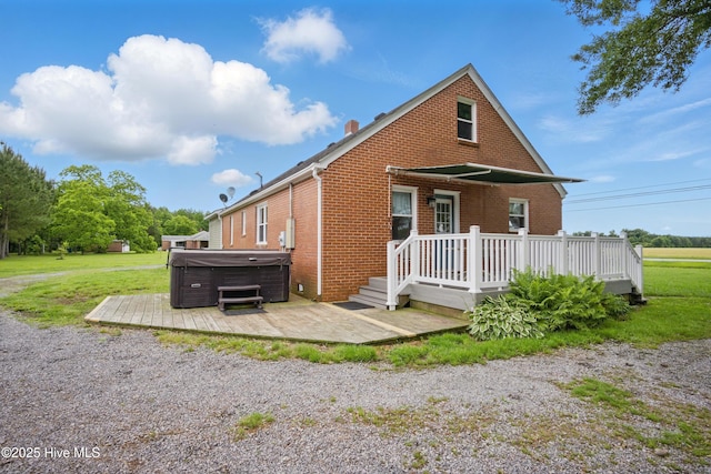 1047 US Highway 158 W, Gates, NC 27937 - view of front of property with a hot tub, brick siding, a wooden deck, a front lawn, and a patio